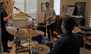 Coppell High School junior Grayson Harris, senior Christian Meyer and Trinity Christian Academy senior Taylor Goode practice multiple times a week at Meyer's house. The band just formed and are preparing for potential live performances. Photo by Kara Hallam.