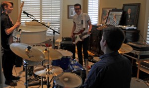 Coppell High School junior Grayson Harris, senior Christian Meyer and Trinity Christian Academy senior Taylor Goode practice multiple times  a week at Meyer's house. The band just formed and are preparing for potential live performances. Photo by Kara Hallam.