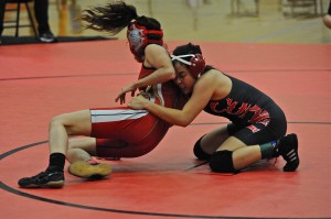 Senior Anna Woo takes down her opponent in the Coppell Cowgirl wrestling team's Cowgirl Classic in the large gym at Coppell High School. Photo by Sarah VanderPol.