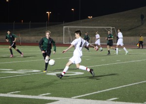 Forward Jake Shumate tries to pass the ball through the Southlake defense in the Cowboys 1-1 tie on Feb. 24. The Cowboys attack only score once, but a week later at Richland they scored 15 times in a 15-0 win. Photo by Nicole Messer.