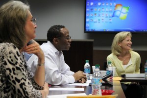 Board of Trustees president Anthony Hill (center) and vice president Susie Kemp (right) discuss policy changes at the special board meeting on April 13. Photo by Amanda Hair.