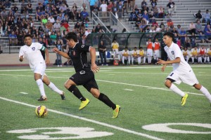 Senior forward Stephen Tower dribbles past the Grand Prairie defense in the Cowboys' 3-2 loss in the 6A Regional Quarterfinals. Tower scored once and was a dominating presence on offense in his final game at Coppell. Photo by Amanda Hair.