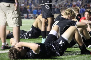 Junior defenseman Andrew Grimmer lays in defeat after the Cowboys' 3-2 loss to the Grand Prairie Gophers on Tuesday night. Grimmer, along with several other varsity underclassmen, will return next year for Coppell. Photo by Amanda Hair.