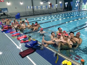 The Coppell High School swim and dive team smile for a picture during practice at the YMCA pool.
