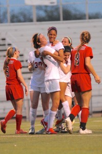 Senior forward Sarah King celebrates with freshman forward Mackenzie McFarland after MacFarland scored her first half goal. The Cowgirls held on to a 2-1 win over McKinney Boyd Tuesday night at Denton High School. Photo by Sarah VanDerPol.