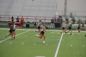 Junior midfield Delaney Dendy and teammates sprint towards the ball during the Playoff game against the Southlake Dragons. Cowgirls won and the next playoff game will be on Saturday. Photo by Aubrie Sisk.