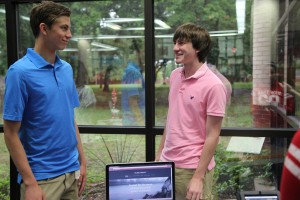 Juniors Stjepan Kilic and Drew Tucker practice explaining their project over music piracy, while in the library during second period on Thursday. Photo by Kelly Monaghan.