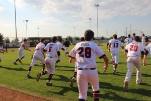 The Cowboys rush the field after Myles Paschall hits a sacrifice fly to end the game in an 11-1 victory on Friday afternoon. With the win, Coppell took home the co-District 7-6A championship. Photo by Shivani Burra.