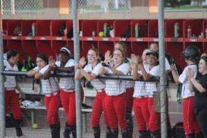 The Cowgirl softball team cheer on their teammates on March 1 at the Coppell baseball/softball Complex. The game, a 6-2 Cowgirl win, evened the playoff series with Midlothian. Photo by Kelly Monaghan.
