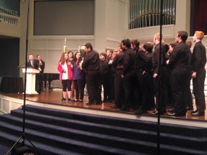 CHS choir director Josh Brown is surrounded by his A Cappella choir while he receives the trophy for first place. Photo courtesy of Josh Brown.