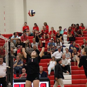 In Coppell’s home match against Richland, CHS freshman setter Mallory Rogers sets the ball to the outside hitter on Sept. 22. Rogers, along with Osuji and Myers, is one of three freshman getting playing time at the varsity level. Photo by Amanda Hair.