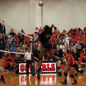 Coppell High School freshman outside hitter Amarachi Osuji goes up for the kill during the Cowgirls’ home match against the Richland Rebels on Sept. 22. “We’re doing really well and we’re working really well together,” Osuji said. Photo by Amanda Hair.