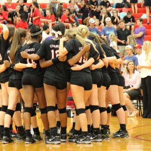 The Coppell volleyball team huddles right before the third set of the game. The Cowgirls went on to win the set 25-9 to earn the win at home. Photo by Amanda Hair.