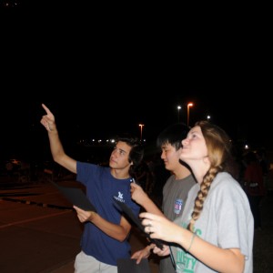 Junior David Gray, seniors Andrew Tao and Melody Siebemann show the constellations present in the sky on Wednesday at the star party. “Scorpio and Orion are never in the sky together because the myth is that the scorpion is always chasing orion but it can never catch him,” Siebemann said. Photo by Alexandra Dalton.
