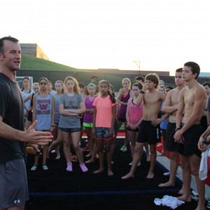 Coppell High School cross country coach Nick Benton instructs the team after running a time trial early Saturday morning at Buddy Echols Field. The varsity team is preparing for a meet on Saturday in Round Rock. The junior varsity team is attending the Jesuit Invitational. Photo by Jennifer Su. 