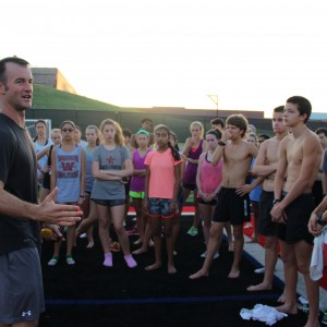 Coppell High School cross country coach Nick Benton instructs the team after running a time trial early Saturday morning at Buddy Echols Field. The varsity team is preparing for a meet on Saturday in Round Rock. The junior varsity team is attending the Jesuit Invitational. Photo by Jennifer Su.