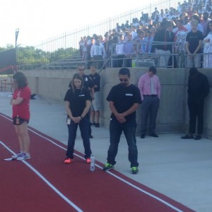 Coppelll High School principal Mike Jasso observes a moment of silence on the anniversary of 9/11 during the homecoming pep rally at Buddy Echols Stadium on Sept. 11. Photo by Mallorie Munoz.