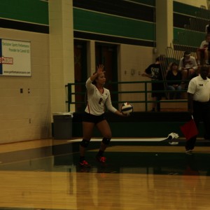 Coppell High School junior libero Lauren Lee serves the ball to the Southlake Dragons during the last volleyball game on Oct 27 held at Southlake High School. After a tough three games the Dragons won and gained the first place district title. Photo by Aubrie Sisk.