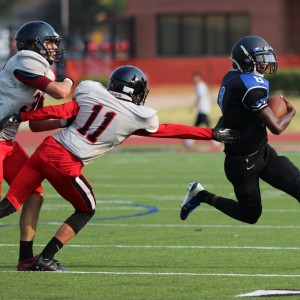 Coppell JV Black cornerback Sam Castranova attempts to tackle Hebron High School player  Aug. 27 at Buddy Echols Field. Castranova is a very versatile player and contributed in the Cowboys 7-6 win.