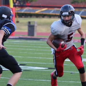 Coppell JV Black wide receiver Michael Quirk carries the ball past the Hebron defender Aug. 27 at Buddy Echols Field. Quirk had many game changing plays in this Cowboys 7-6 win. 