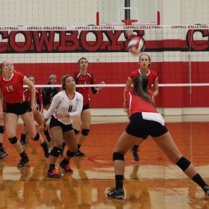 Coppell High School junior Lauren Lee watches her teammate hit the ball during a home game on Sept. 1. Lee is playing her third year on the Cowgirls volleyball team. Photo by Kelly Monaghan.