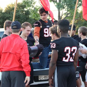 Coppell High School’s varsity football team holds their Give Back Night fundraiser on Tuesday in the Chipotle parking lot. The team collected donated blankets for the Austin Street Center transitional living facility for those with employment, substance abuse and psychological needs in downtown Dallas. “[The fundraiser] is a great way for people to come show their support for Coppell football and a great way to support our community as a whole for a good cause,” senior Zaid Albarmawi said. Photo by Alexandra Dalton. 