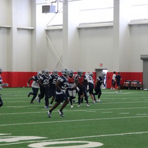 The Dallas Cowboys practice in the newly renovate Coppell High School fieldhouse on Friday. Practice was moved to CHS because of the weather conditions. Photo by Mallorie Munoz.