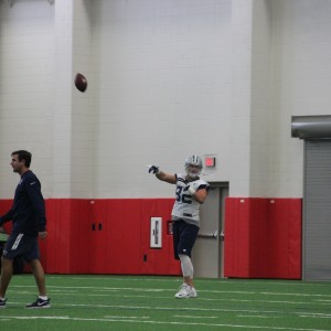 Dallas Cowboys tight end Jason Witten makes a pass during Friday morning's practice at Coppell High School's newly renovated fieldhouse. Practice was moved to CHS due to rainy weather. Photo by Mallorie Munoz.
