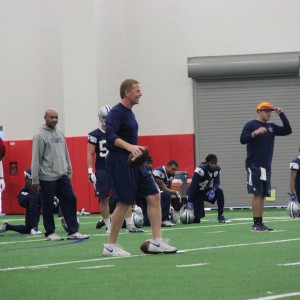 Dallas Cowboys head coach Jason Garrett prepares the team for Sunday's game during Friday morning's practice at Coppell High School's newly renovated fieldhouse. Practice was moved to CHS due to rainy weather conditions. Photo by Mallorie Munoz.
