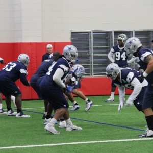 The Dallas Cowboys practice in the newly renovate Coppell High School fieldhouse on Friday. Practice was moved to CHS because of the weather conditions. Photo by Mallorie Munoz.