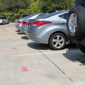 Eighty additional senior parking spots were added into the student parking lot at Coppell High School on the morning of Sept. 30. These parking spots are marked with red stripes. Photo by Sruthi Boppuri. 