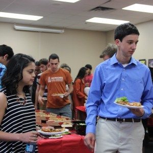 Coppell High School Merit scholars pick up food to eat before the awards are given out on Wednesday in the Coppell High School library. There was 113 students that were nationally recognized for their PSAT scores. Photo by Ale Ceniceros. 