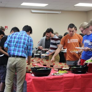 Coppell High School Merit scholars have some pizza, salad and cookies for lunch in the library on Wednesday during all lunches. There was 113 students that were nationally recognized for their PSAT scores. Photo by Ale Ceniceros. 