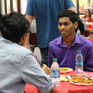 Coppell High School National Merit commended senior Srujan Esanakarra socializes with his peers during the National Merit luncheon. There was 113 students that were nationally recognized for their PSAT scores. Photo by Ale Ceniceros. 