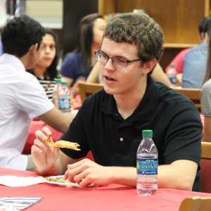 Coppell High School National Merit scholar senior Joseph Overman enjoys a nice lunch provided by the school for his success on Wednesday in the library. There was 113 students that were nationally recognized for their PSAT scores. Photo by Ale Ceniceros. 