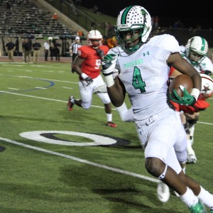 Southlake Carroll High School varsity player runs with the ball on offence against the Coppell Cowboys. After double over-time at Buddy Echols Field the Southlake Dragons win by one point 38-37. Photo by Megan Winkle.