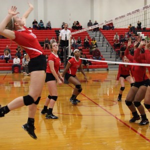 Coppell High School junior Katie Herklotz prepares to hit over the net on the right side.The Cowgirls won all three sets, the first with a score of 25-9, 25-17, and 25-11 on Friday night's game in the CHS large gym. Photo by Megan Winkle. 