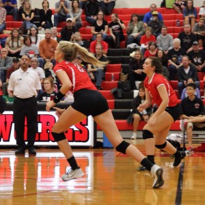 Coppell High School senior Kylie Hagen-Breitenwischer runs to cover the floor along with other varsity players. The Cowgirls won all three sets, the first with a score of 25-9, 25-17, and 25-11 on Friday night's game in the CHS large gym. Photo by Megan Winkle. 