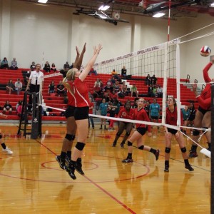 Coppell High School junior Katie Herklotz and freshman Mykayla Myers blocks the ball while the Trinity High School player spikes the ball. The Cowgirls won all three sets, the first with a score of 25-9, 25-17, and 25-11 on Friday night's game in the CHS large gym. Photo by Megan Winkle. 