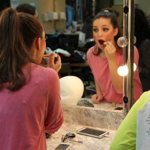 Junior Natalie Weix applies lipstick in the Green Room in preparation for her performance in “Big Fish” the musical at Coppell High School on Oct. 30. “Big Fish” is the fifth show Weix has been in at CHS and the third musical. She played an Alabama Lamb and was a member of the ensemble in Big Fish. Photo by Maggie Theel.