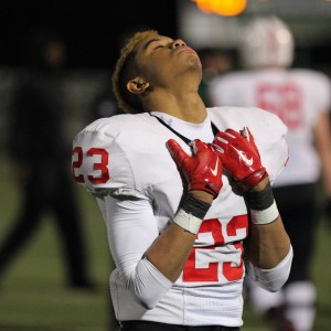 After losing to the DeSoto Eagles, Coppell High School freshman and defensive back Jonathan McGill hangs his head in defeat on Friday night at Eagle Stadium. The Eagles claimed a victory over Coppell with a score of 35-31, ending the Cowboys’ season. Photo by Amanda Hair. 