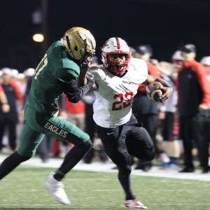 During the first quarter on Friday night’s game, Coppell High School senior and running back Brandon Rice dodges DeSoto players as he goes in for a touchdown. The DeSoto Eagles claimed a victory over Coppell with a final score of 35-31, ending Coppell’s season. Photo by Amanda Hair. 