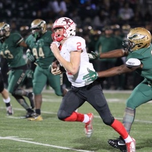 Coppell High School sophomore and quarterback Brady McBride runs the ball towards the end zone during the end of the first quarter on Friday night’s game at Eagle Stadium. The DeSoto Eagles defeated Coppell with a final score of 35-31, knocking Coppell out of the playoffs. Photo by Amanda Hair. 