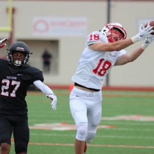 During the first quarter, Coppell High School senior and wide receiver Luke Conlon jumps to catch a pass from quarterback Brady McBride. The Coppell Cowboys ended Saturday’s rescheduled game with a final score of 19-14, defeating the Colleyville Heritage Panthers. Photo by Amanda Hair. 