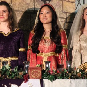 Coppell High School juniors Pam Mason, Esther Cha, and Alli Judd (left to right) prepare to eat dinner while guests are being served in the CHS large commons during Friday night’s Madrigals performance. There is another show on Saturday starting at 6:30p.m., and each dinner ticket is $30, while dessert tickets are $10. Photo by Amanda Hair.