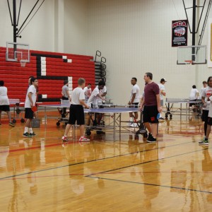 Coppell High School P.E. students play ping pong in the small gym during fifth period today. They play different sports every week, giving students a chance to learn all of the different kinds of sports. 