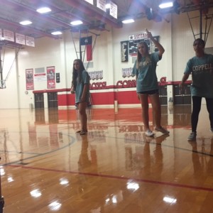 Coppell High School junior Adhithi Baskar and freshmen Aubrey Phillips and Jordan Owens play Wii sports during their second period Aerobics class in the large gym. Aerobics is currently working on their walking unit and the groups that were done first got this reward. 