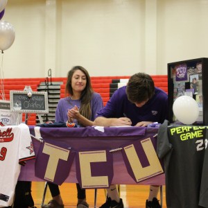Coppell High School varsity pitcher Charles King signs to Texas Christian University to play baseball on the morning of Nov.11, National Signing Day as his sister proudly watches. His sister, CHS graduate, Sarah King signed to Baylor University to play soccer last school year. Photo by Kelly Monaghan.