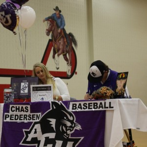 Coppell High School  varsity infielder Chas Pederson signs to Abilene Christian University to play baseball the morning of Nov. 11 in the CHS large gym. Five out of nine students who signed letters of intent signed to play baseball in college. Photo by Kelly Monaghan.