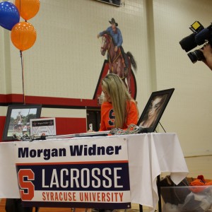 C2C Lacrosse defensive player Morgan Widner signs to Syracuse University to play lacrosse the morning of Nov. 11 in the CHS large gym. Nine CHS athletes signed their letters of intent on National Signing Day. Photo by Kelly Monaghan.